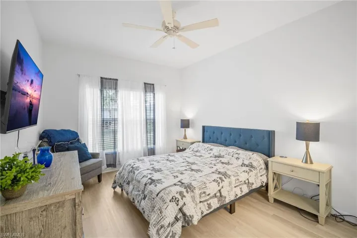 Bedroom with ceiling fan and wood finished floors