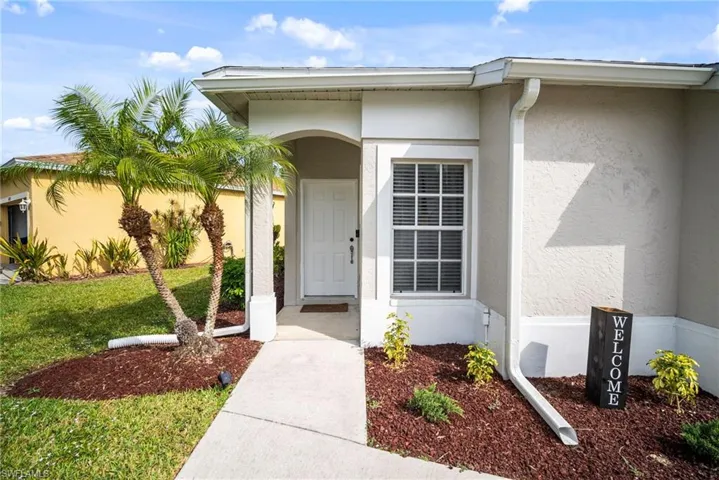 Entrance to property featuring stucco siding