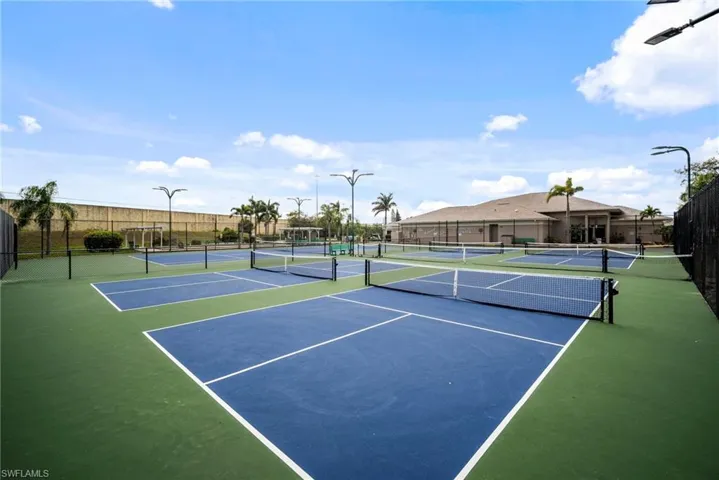 View of tennis court featuring fence