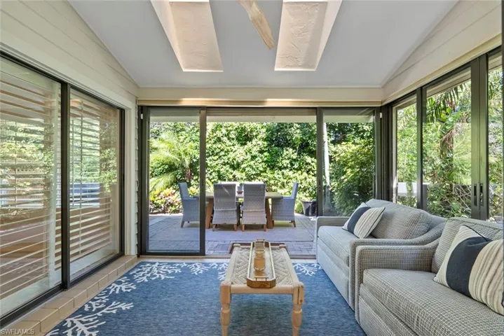 Sunroom featuring vaulted ceiling and a wealth of natural light