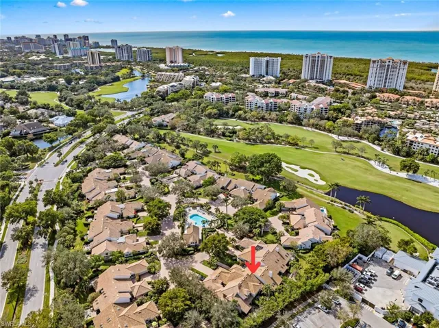 Birds eye view of property with a water view