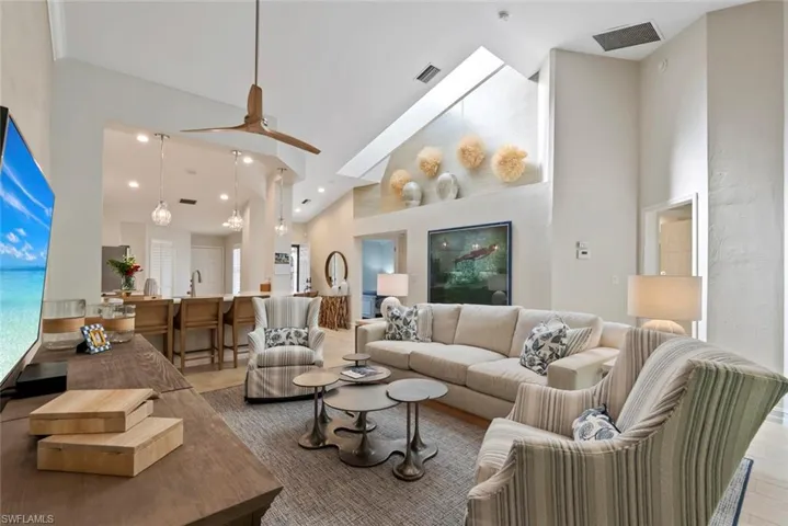 Living room with sink and high vaulted ceiling