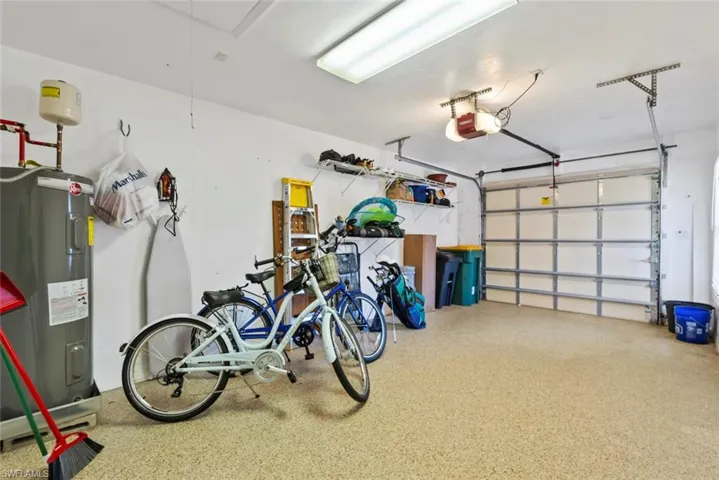 Garage with a garage door opener and electric water heater