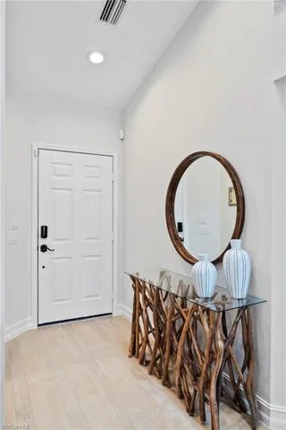 Entrance foyer with light hardwood / wood-style flooring