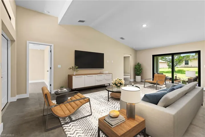 Virtually Staged for illustrative Purposes. Living room with vaulted ceiling
