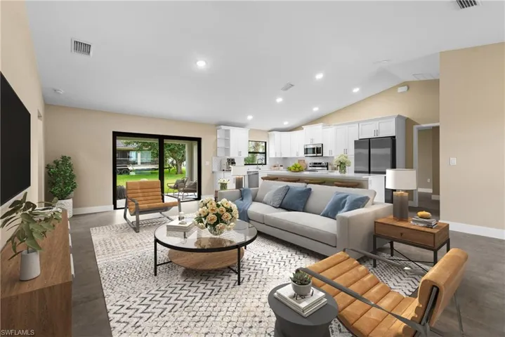 Virtually Staged for illustrative Purposes. Living room featuring vaulted ceiling