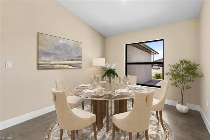 Virtually Staged for illustrative Purposes. Tiled dining room featuring lofted ceiling