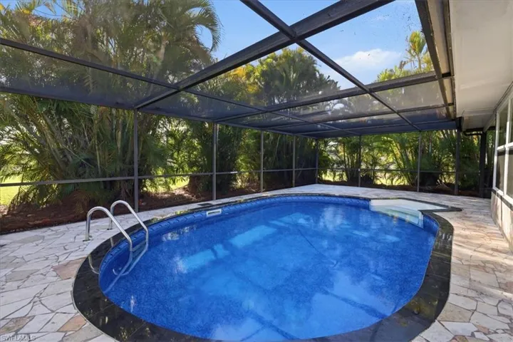 old Outdoor pool with a patio, a sunroom, and a lanai