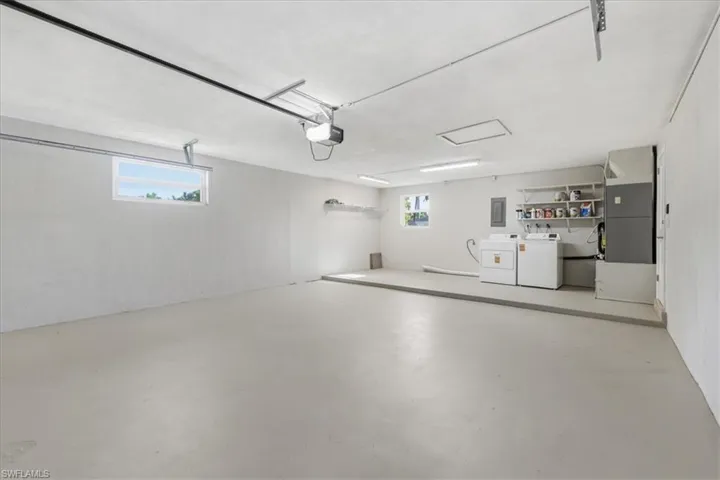 Garage with heating unit, washer and dryer, and electric panel