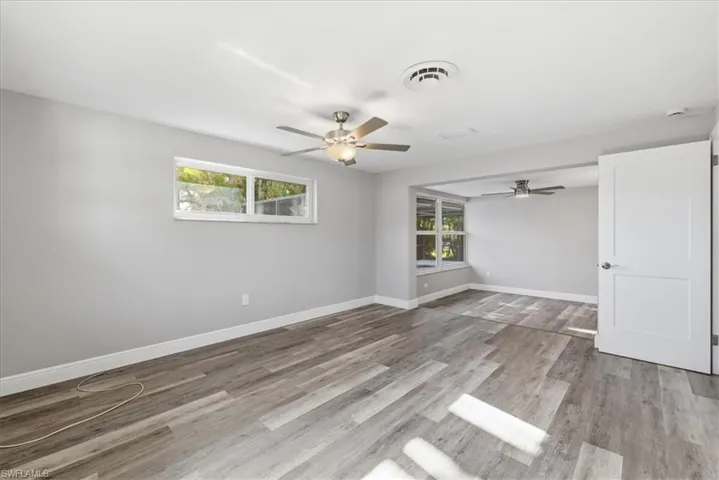 Master bedroom featuring ceiling fan, light wood-style flooring, and healthy amount of natural light