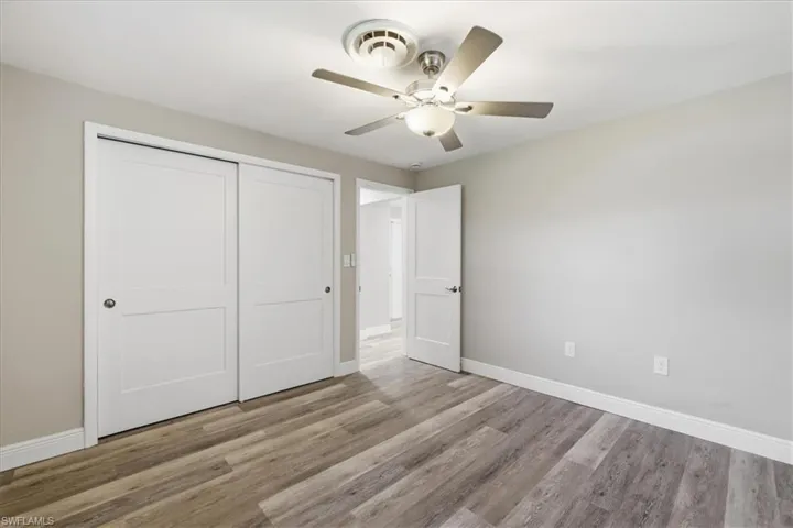 Unfurnished bedroom with a closet, light wood-style floors, and ceiling fan