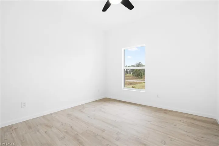 Empty room featuring ceiling fan and light wood-type flooring