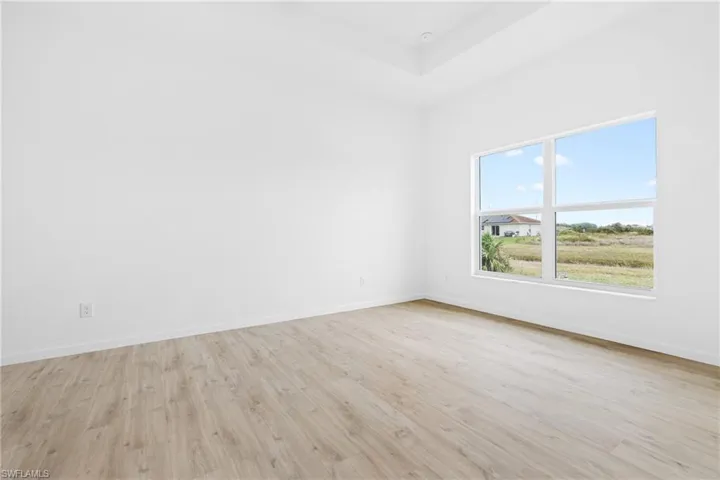 Empty room with light hardwood / wood-style flooring