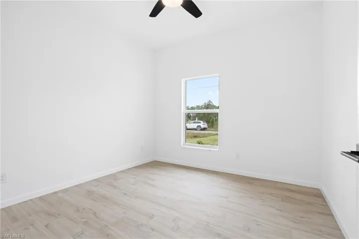 Unfurnished room featuring ceiling fan and light hardwood / wood-style flooring