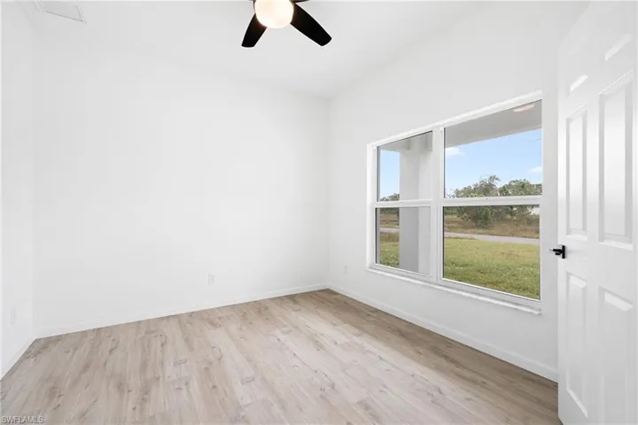 Empty room with light wood-type flooring and ceiling fan