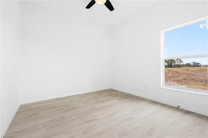 Spare room with light hardwood / wood-style flooring and ceiling fan