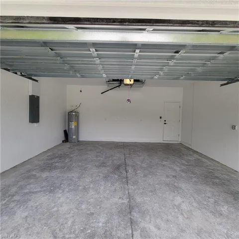 Garage with water heater and electric panel
