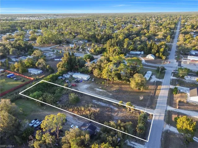 Aerial perspective of suburban area featuring property boundaries highlighted