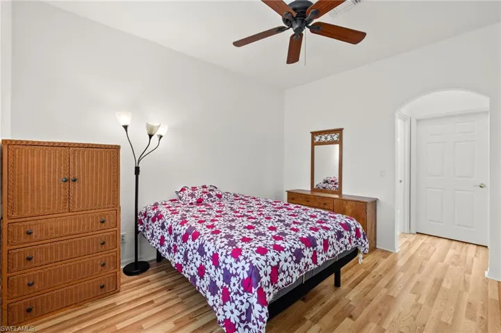 Bedroom with ceiling fan and light hardwood / wood-style flooring