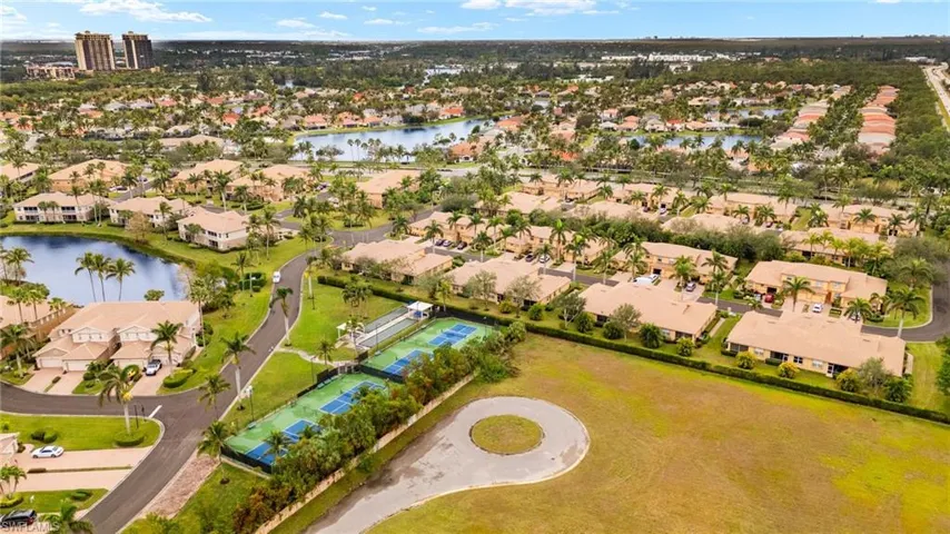 Birds eye view of property with a water view