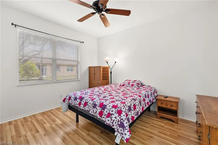 Bedroom with ceiling fan and light hardwood / wood-style floors