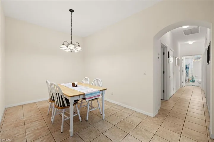 Dining room featuring light tile patterned floors and a chandelier