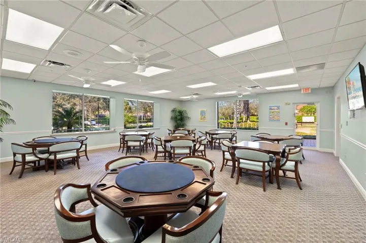 Game room featuring ceiling fan, a paneled ceiling, and light carpet