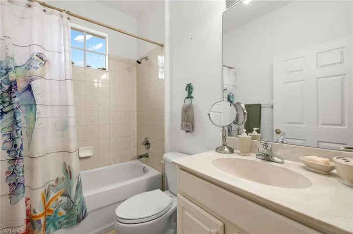 Full bathroom with vanity, toilet, and shower / bath combo