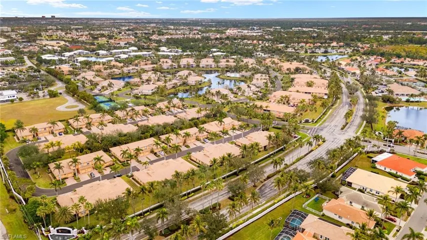 Birds eye view of property with a water view