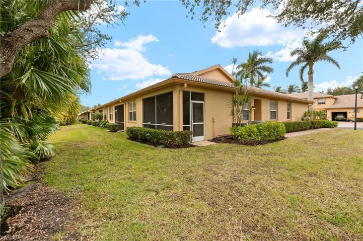 Back of property with a lawn