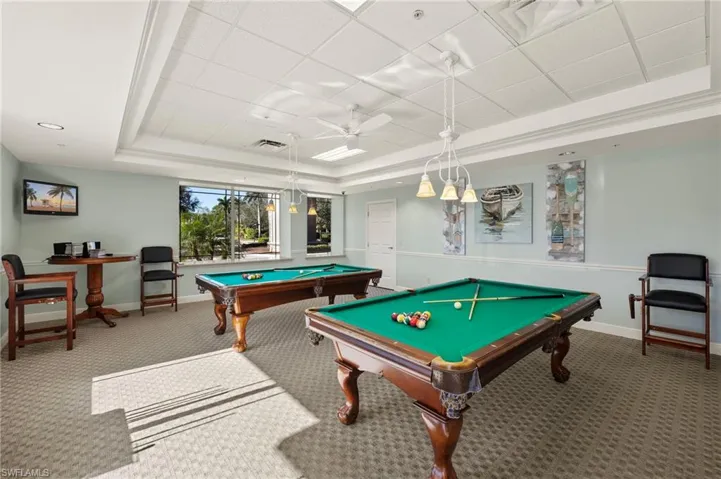 Playroom with a raised ceiling, carpet, ceiling fan, and billiards
