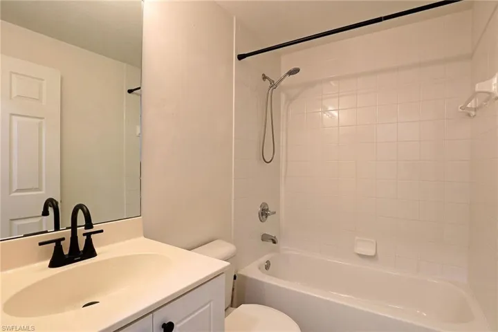 Bathroom with shower / bath combination and vanity