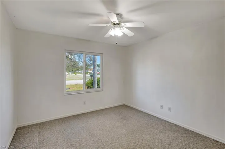 Bedroom #1 with lots of natural light and view of the front of the house. Hurricane impact window.