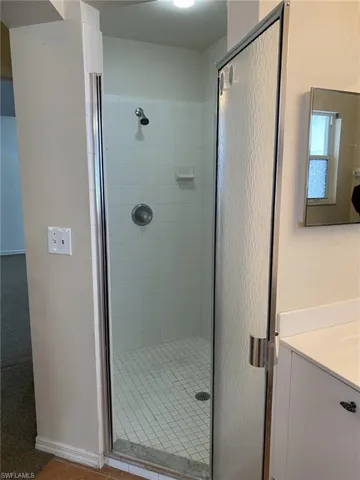Bathroom featuring an enclosed shower and vanity