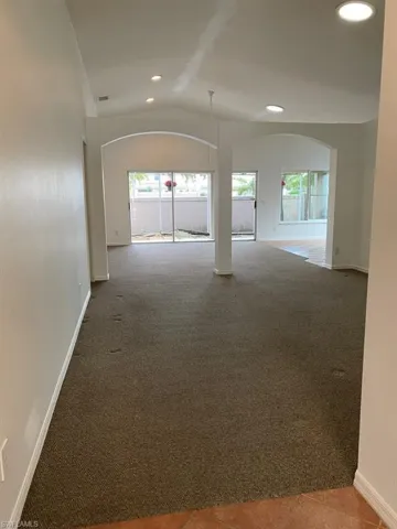 View of living flex room & living room. Beautiful Open Concept, natural light and vaulted ceilings.