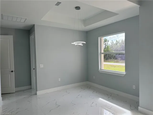 Spare room with a tray ceiling