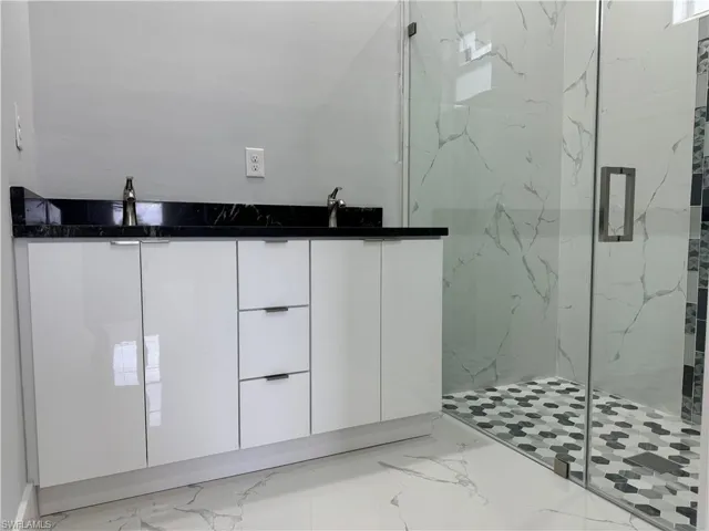 Bathroom with walk in shower and sink