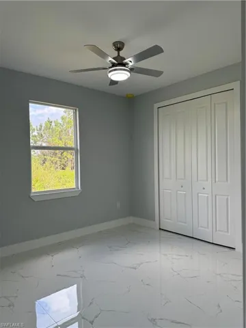 Unfurnished bedroom with a closet and ceiling fan
