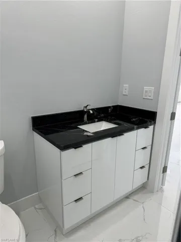 Bathroom with vanity and toilet