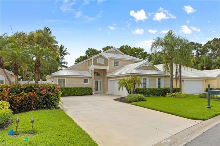 View of front property with a garage and a front yard