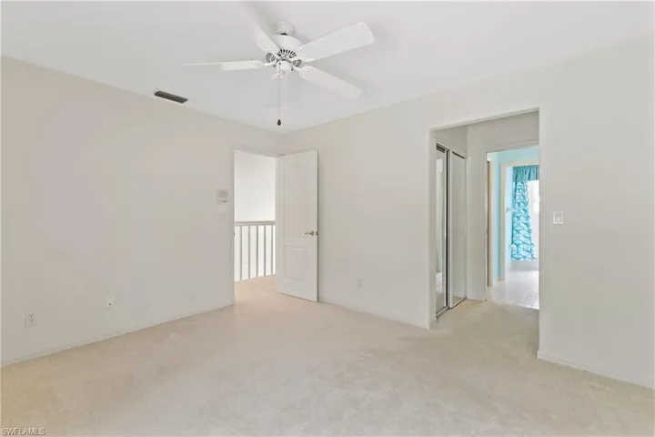 Spare room with light colored carpet and ceiling fan