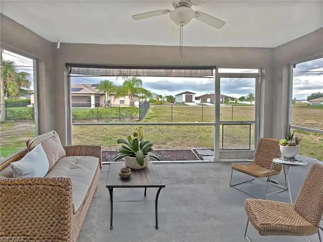 Sunroom with a ceiling fan, outdoor lounge area, and a wealth of natural light