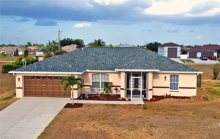 Ranch-style house with driveway, french doors, a residential view, an attached garage, and stucco siding