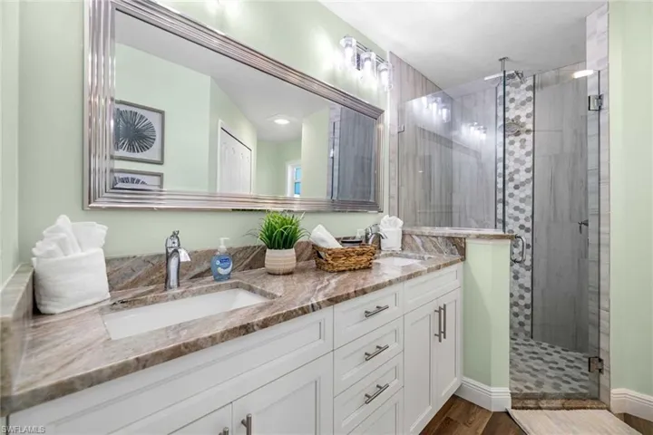 Primary bathroom has a double-sink vanity & walk-in shower