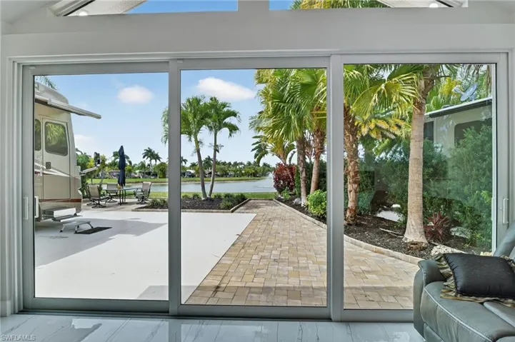 Doorway featuring a water view, healthy amount of natural light, and wood finished floors