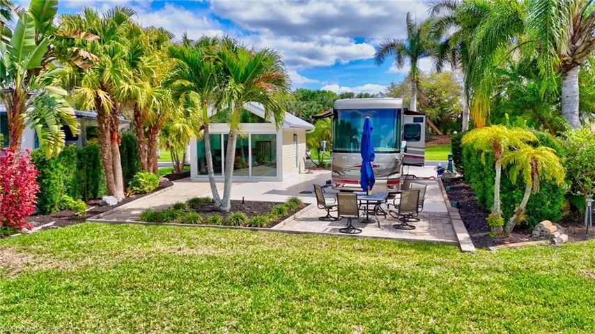 Back of property with a yard and a patio