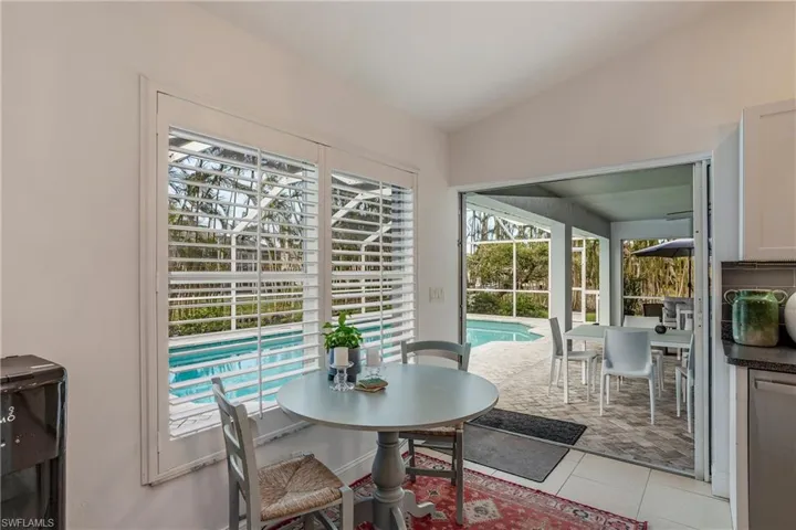 Dining space with light tile patterned floors