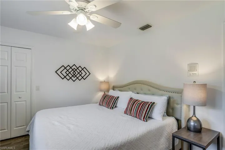 Bedroom with a ceiling fan, wood finished floors, and a closet