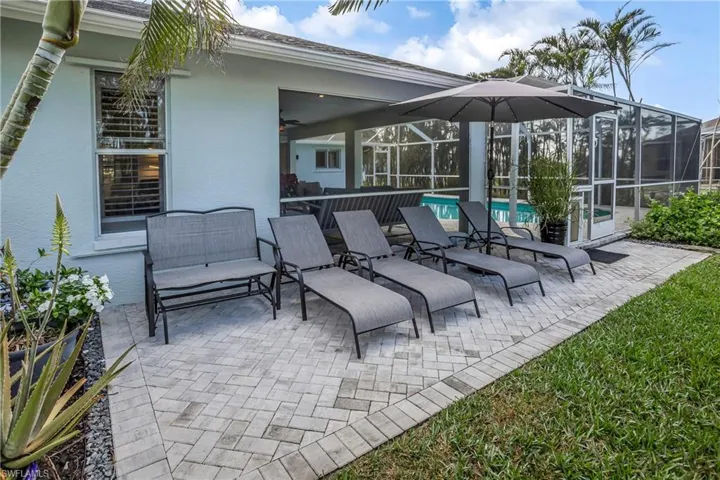 View of patio / terrace featuring an outdoor pool and a lanai