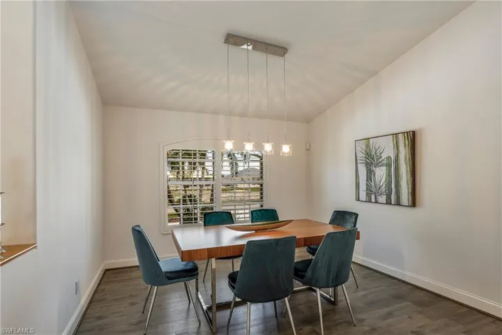 Dining area featuring wood finished floors and lofted ceiling